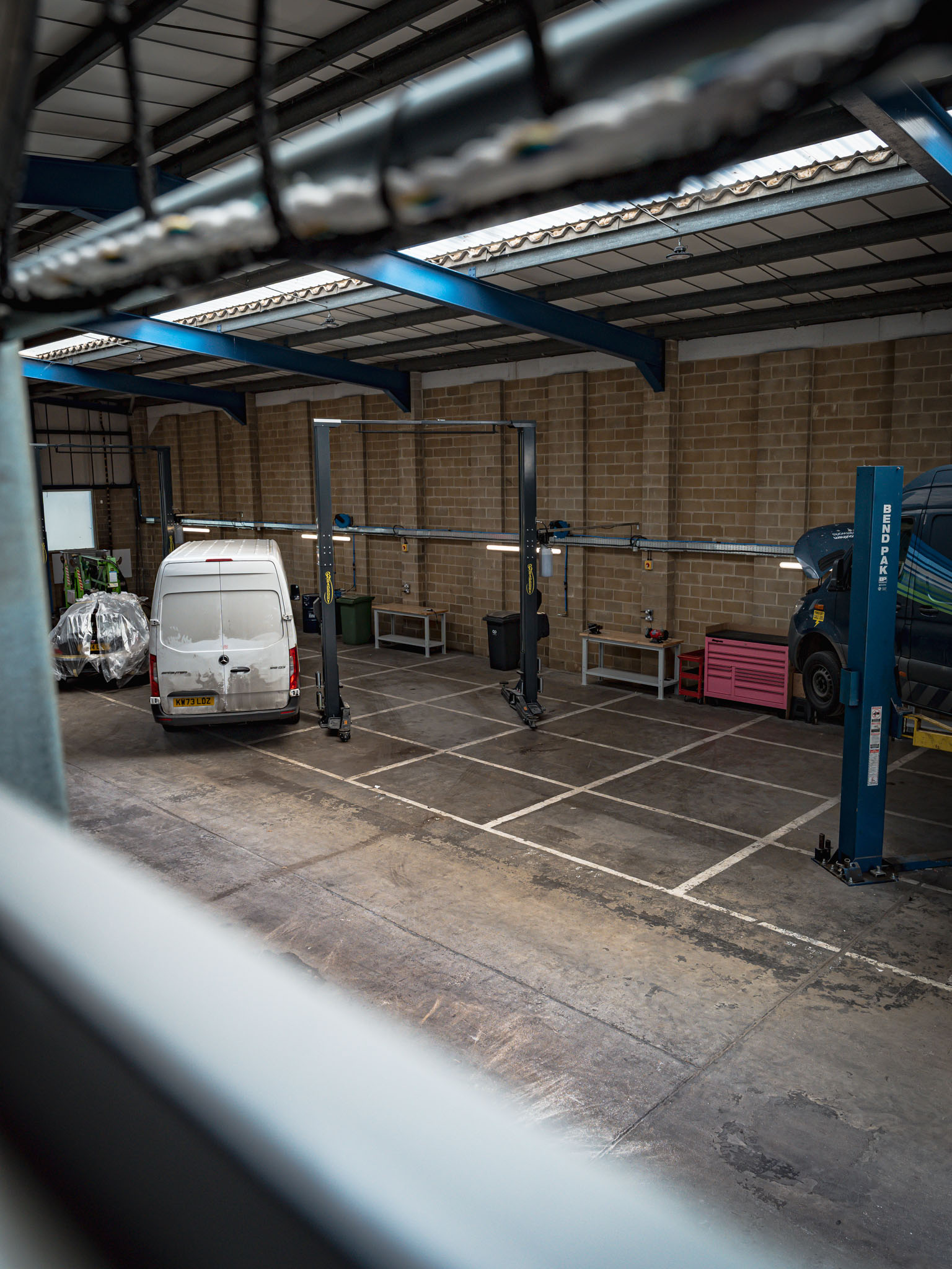 Multiple Best Autocentres Totton bays in use, with vans and a car raised on lifts