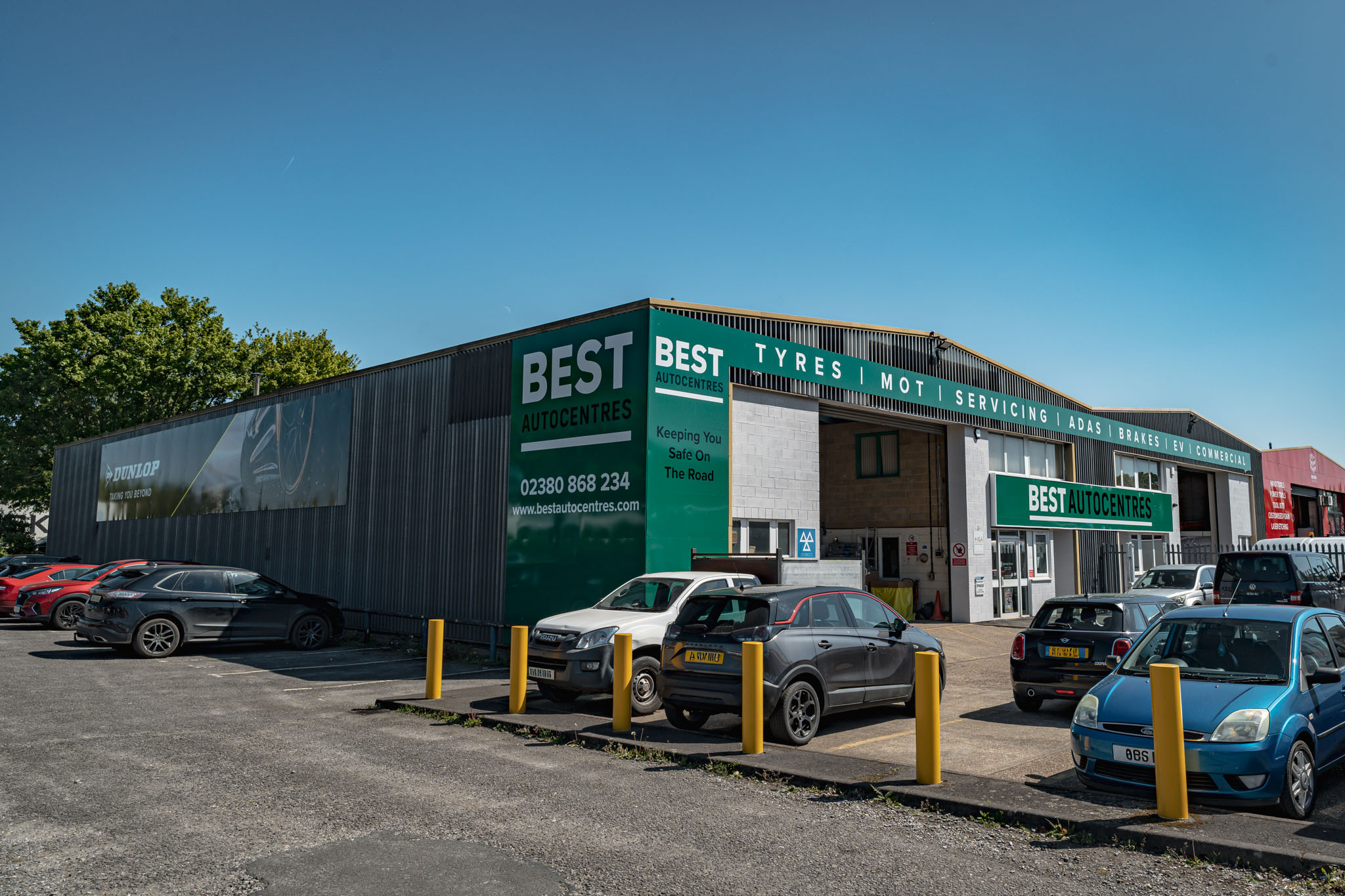 Best Autocentres Totton frontage with MOT signage and open workshop bays